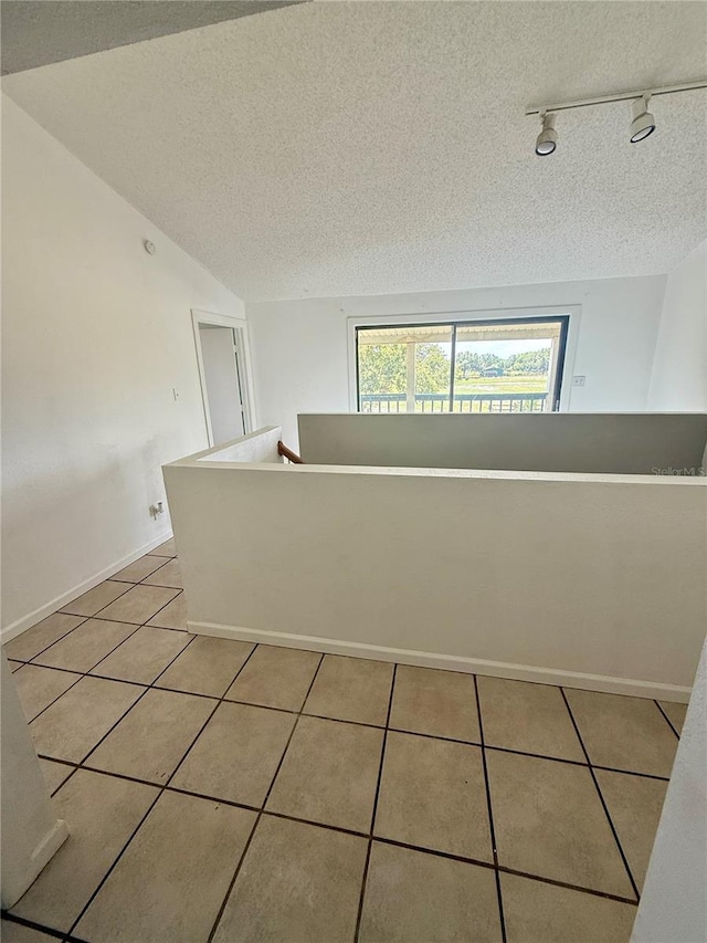 439 Corbett Rd, Lithia, FL 33547 - unfurnished room with track lighting, light tile patterned flooring, a textured ceiling, and baseboards