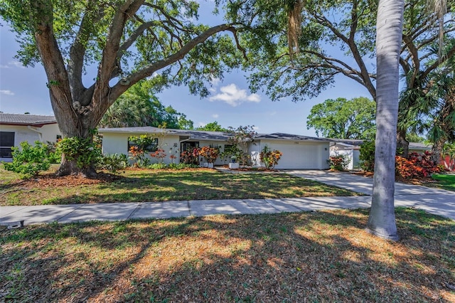 1766 Hitching Post Ln, Dunedin, FL 34698 - view of front of home featuring driveway, a garage, and a front yard