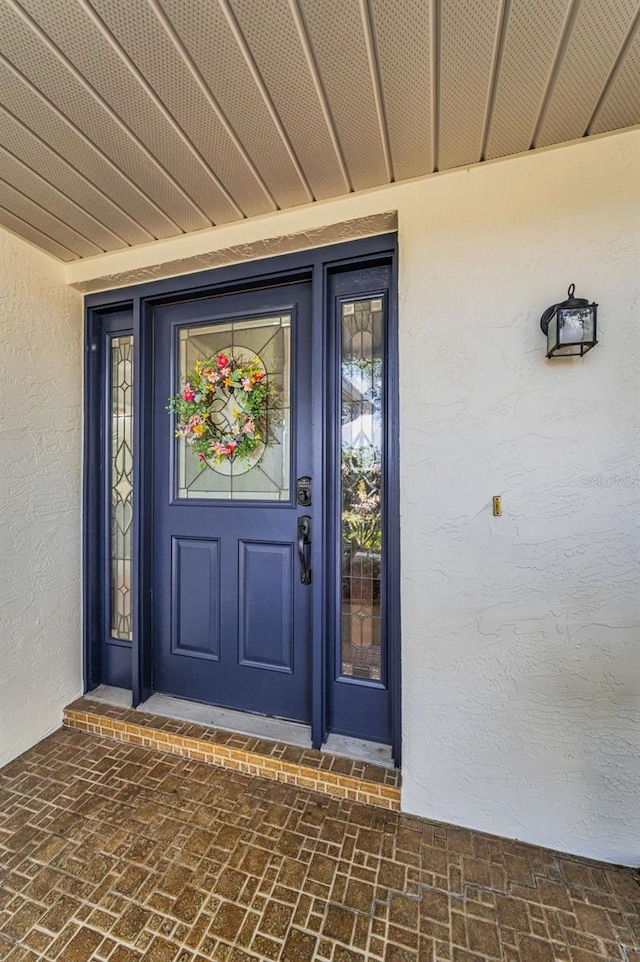 1766 Hitching Post Ln, Dunedin, FL 34698 - property entrance featuring stucco siding