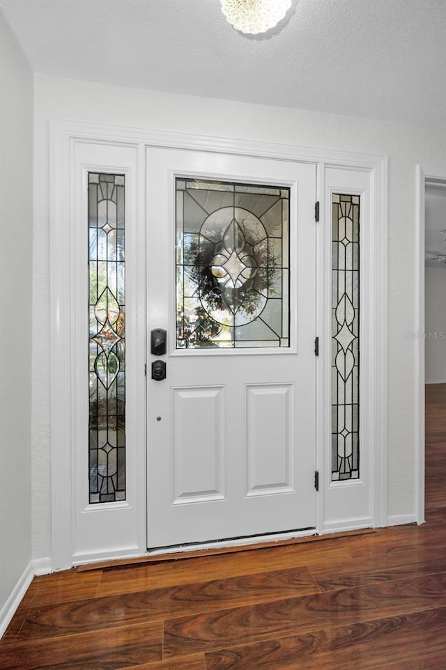 1766 Hitching Post Ln, Dunedin, FL 34698 - entrance foyer with baseboards and wood finished floors