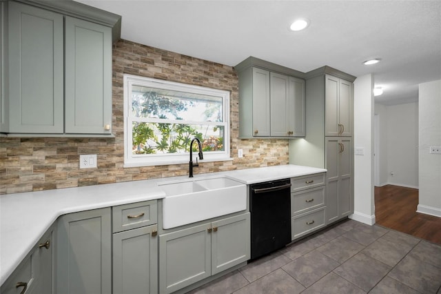 1766 Hitching Post Ln, Dunedin, FL 34698 - kitchen with a sink, dishwasher, gray cabinetry, backsplash, and light countertops