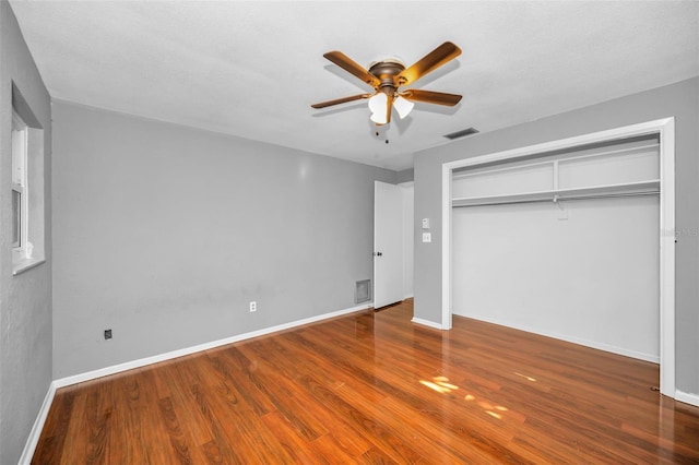 1766 Hitching Post Ln, Dunedin, FL 34698 - unfurnished bedroom with wood finished floors, a closet, and baseboards