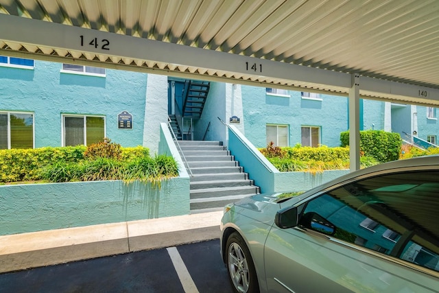 255 114th Ave N Unit 4, Saint Petersburg, FL 33716 - doorway to property featuring stucco siding and covered parking