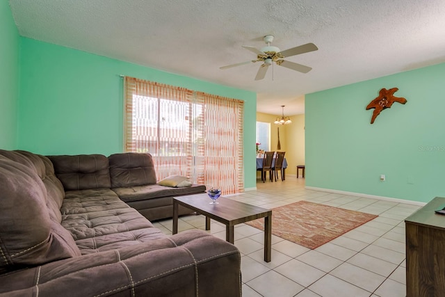 255 114th Ave N Unit 4, Saint Petersburg, FL 33716 - living room featuring ceiling fan, light tile patterned floors, a chandelier, a textured ceiling, and baseboards