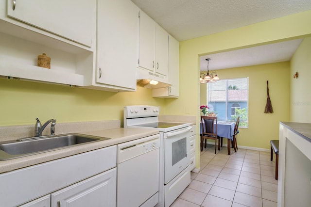 255 114th Ave N Unit 4, Saint Petersburg, FL 33716 - kitchen with under cabinet range hood, white appliances, a sink, white cabinets, and a chandelier