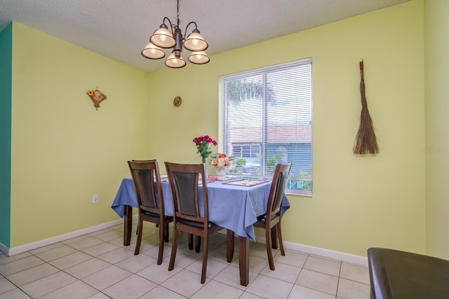 255 114th Ave N Unit 4, Saint Petersburg, FL 33716 - dining room with a chandelier, a textured ceiling, baseboards, and light tile patterned floors