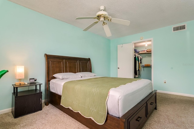 255 114th Ave N Unit 4, Saint Petersburg, FL 33716 - bedroom featuring light carpet, a spacious closet, baseboards, a closet, and a textured ceiling
