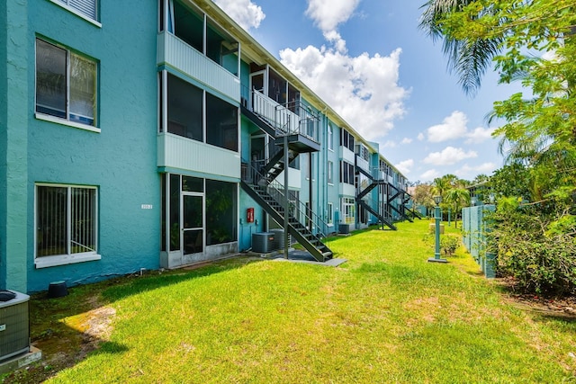255 114th Ave N Unit 4, Saint Petersburg, FL 33716 - view of grassy yard with cooling unit and stairway