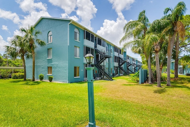 255 114th Ave N Unit 4, Saint Petersburg, FL 33716 - view of building exterior featuring central AC and stairway