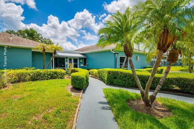 255 114th Ave N Unit 4, Saint Petersburg, FL 33716 - view of front of property featuring stucco siding and a front yard