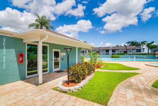 255 114th Ave N Unit 4, Saint Petersburg, FL 33716 - view of green lawn featuring a community pool and a patio