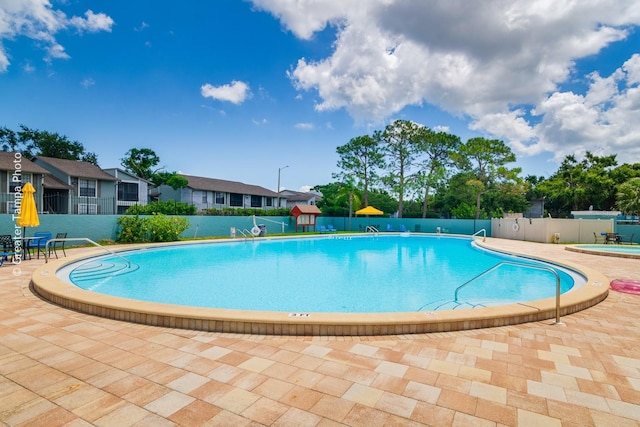 255 114th Ave N Unit 4, Saint Petersburg, FL 33716 - community pool with a patio and a residential view
