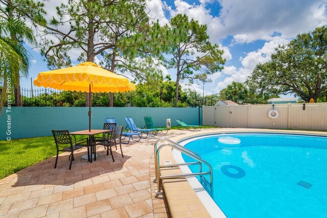 255 114th Ave N Unit 4, Saint Petersburg, FL 33716 - view of swimming pool with a patio area and a fenced backyard