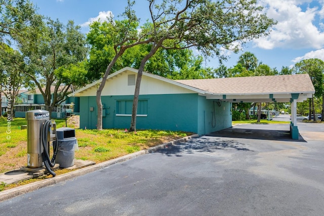 255 114th Ave N Unit 4, Saint Petersburg, FL 33716 - view of side of property featuring driveway and a carport