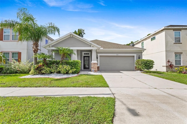 7725 Tangle Rush Dr, Gibsonton, FL 33534 - view of front of house featuring a garage, a front lawn, concrete driveway, and stucco siding