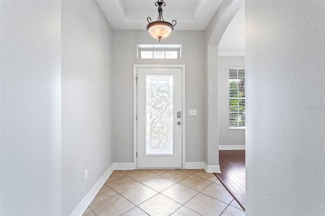 7725 Tangle Rush Dr, Gibsonton, FL 33534 - entrance foyer with arched walkways, light tile patterned floors, baseboards, and a tray ceiling