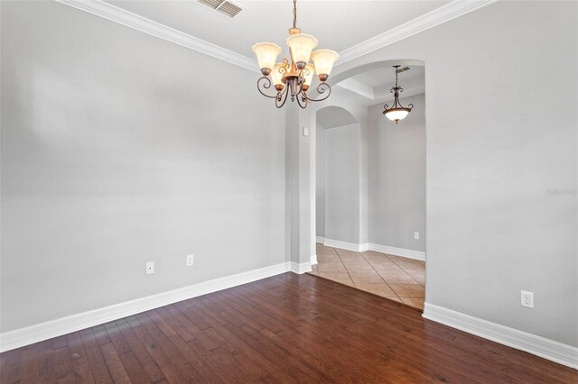 7725 Tangle Rush Dr, Gibsonton, FL 33534 - empty room featuring arched walkways, a chandelier, wood finished floors, baseboards, and ornamental molding