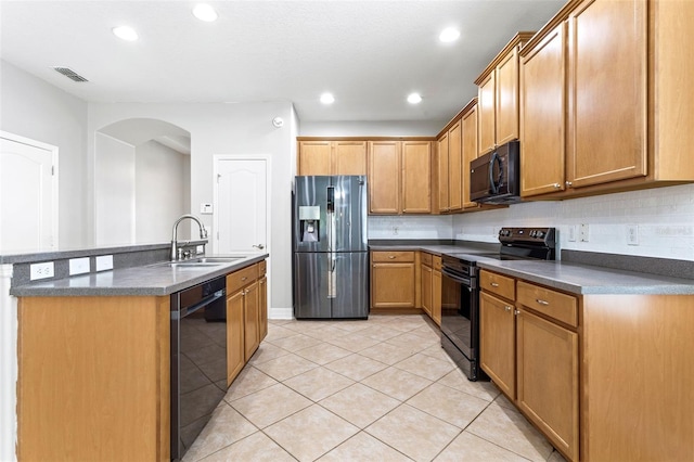 7725 Tangle Rush Dr, Gibsonton, FL 33534 - kitchen with black appliances, a sink, dark countertops, arched walkways, and recessed lighting