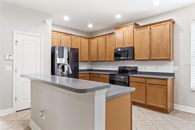 7725 Tangle Rush Dr, Gibsonton, FL 33534 - kitchen with appliances with stainless steel finishes, light tile patterned floors, a sink, baseboards, and a center island with sink