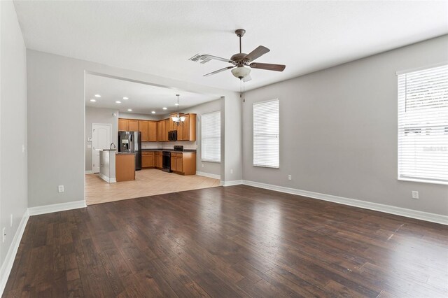 7725 Tangle Rush Dr, Gibsonton, FL 33534 - unfurnished living room featuring ceiling fan, light wood finished floors, baseboards, and recessed lighting