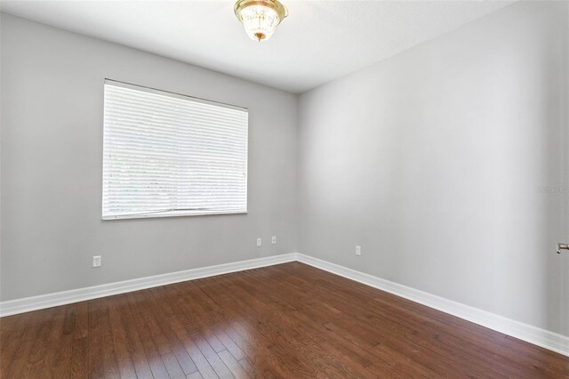 7725 Tangle Rush Dr, Gibsonton, FL 33534 - spare room with dark wood-style floors and baseboards