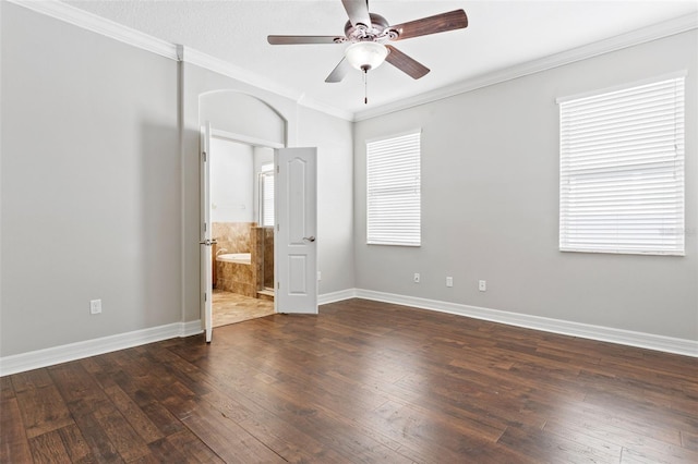 7725 Tangle Rush Dr, Gibsonton, FL 33534 - unfurnished bedroom featuring dark wood-style flooring, baseboards, ornamental molding, ceiling fan, and ensuite bathroom