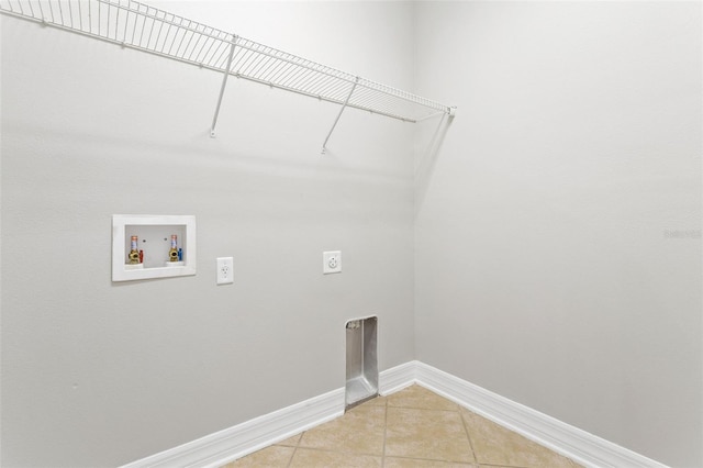 7725 Tangle Rush Dr, Gibsonton, FL 33534 - washroom with hookup for an electric dryer, washer hookup, light tile patterned floors, and baseboards