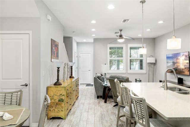12353 Bayou Flats Ln, Tampa, FL 33635 - kitchen with a sink, ceiling fan, recessed lighting, decorative light fixtures, and light wood-style floors