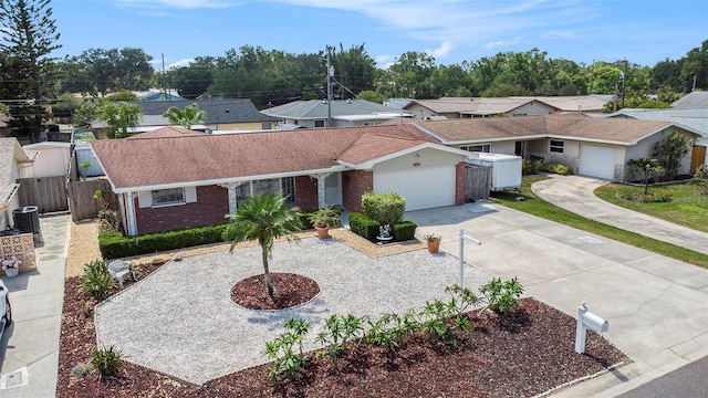 10400 112th Way, Largo, FL 33778 - single story home featuring an attached garage, brick siding, concrete driveway, and roof with shingles
