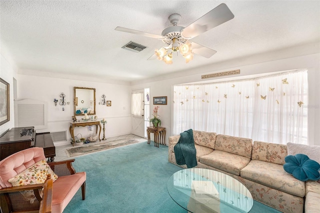 10400 112th Way, Largo, FL 33778 - carpeted living room with a ceiling fan and a textured ceiling