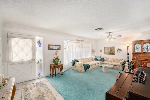 10400 112th Way, Largo, FL 33778 - living room featuring a ceiling fan, a textured ceiling, and light tile patterned floors