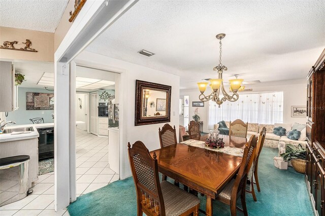 10400 112th Way, Largo, FL 33778 - dining space featuring a chandelier, a textured ceiling, and light tile patterned floors