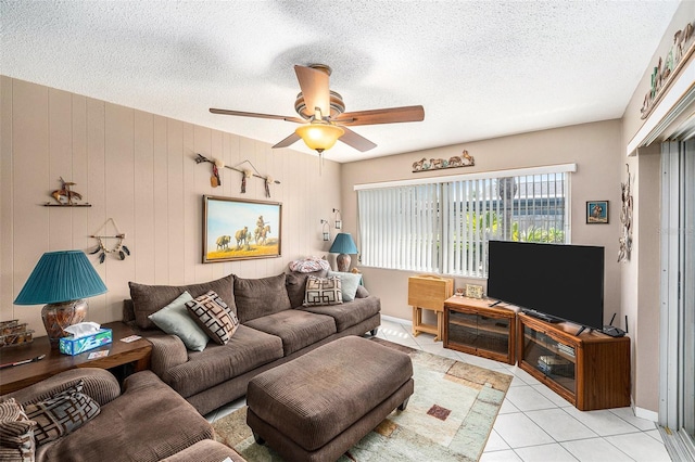 10400 112th Way, Largo, FL 33778 - living room with a ceiling fan, a textured ceiling, light tile patterned floors, and baseboards