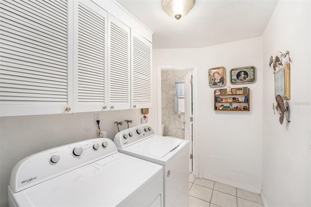 10400 112th Way, Largo, FL 33778 - washroom with separate washer and dryer, cabinet space, light tile patterned flooring, and baseboards