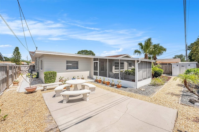 10400 112th Way, Largo, FL 33778 - rear view of house with a sunroom, a patio area, and a fenced backyard