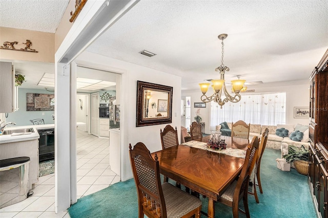 10400 112th Way, Largo, FL 33778 - dining space with a chandelier, a textured ceiling, and light tile patterned floors
