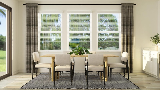11757 E 74th Cir, Palmetto, FL 34221 - dining space with light wood finished floors, plenty of natural light, and baseboards
