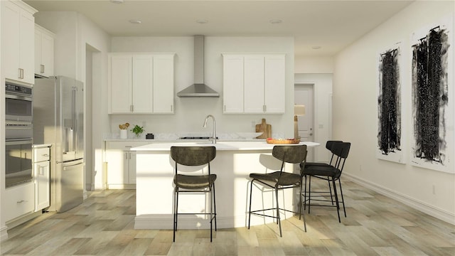11757 E 74th Cir, Palmetto, FL 34221 - kitchen with appliances with stainless steel finishes, wall chimney range hood, light wood finished floors, a kitchen island with sink, and white cabinetry