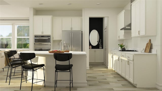 11757 E 74th Cir, Palmetto, FL 34221 - kitchen with stainless steel appliances, white cabinets, light wood-style flooring, and a kitchen island with sink