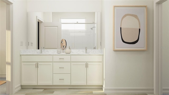 11757 E 74th Cir, Palmetto, FL 34221 - full bathroom featuring double vanity, tiled shower, wood finished floors, and baseboards