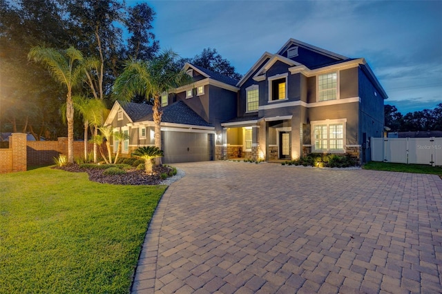 1229 Hillandale Reserve Dr, Tampa, FL 33613 - view of front of house with stucco siding, a gate, decorative driveway, and an attached garage