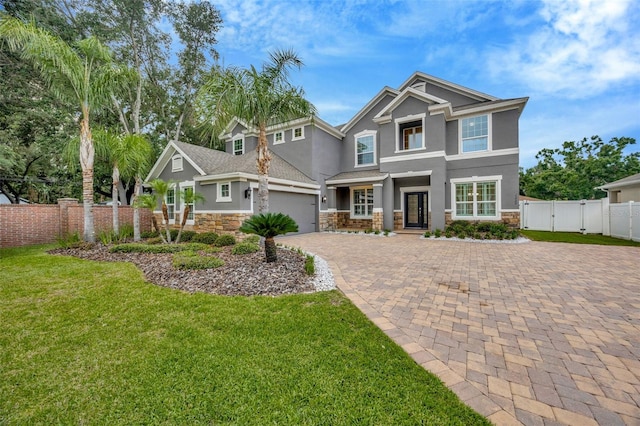 1229 Hillandale Reserve Dr, Tampa, FL 33613 - craftsman-style house with stucco siding, a gate, stone siding, and driveway
