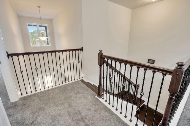 1229 Hillandale Reserve Dr, Tampa, FL 33613 - staircase featuring carpet flooring and a chandelier