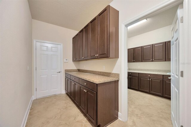 1229 Hillandale Reserve Dr, Tampa, FL 33613 - kitchen featuring light countertops and dark brown cabinets