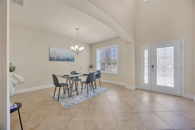 1229 Hillandale Reserve Dr, Tampa, FL 33613 - tiled dining room with arched walkways and a chandelier