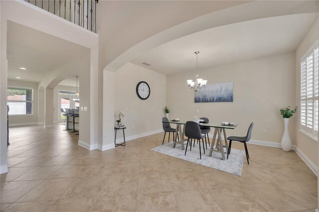 1229 Hillandale Reserve Dr, Tampa, FL 33613 - dining room featuring arched walkways, a chandelier, and healthy amount of natural light