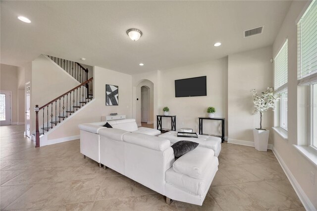 1229 Hillandale Reserve Dr, Tampa, FL 33613 - living room with arched walkways, stairway, plenty of natural light, and recessed lighting