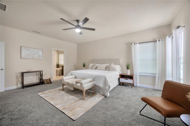 1229 Hillandale Reserve Dr, Tampa, FL 33613 - carpeted bedroom featuring multiple windows, a textured ceiling, a ceiling fan, and ensuite bathroom