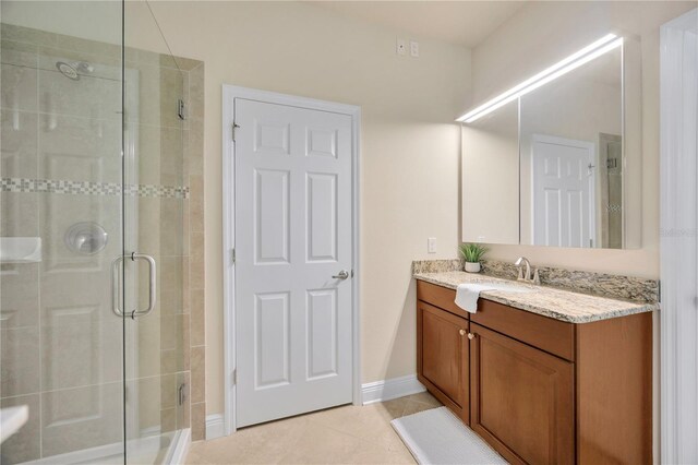 1229 Hillandale Reserve Dr, Tampa, FL 33613 - bathroom featuring vanity, a shower stall, and tile patterned flooring