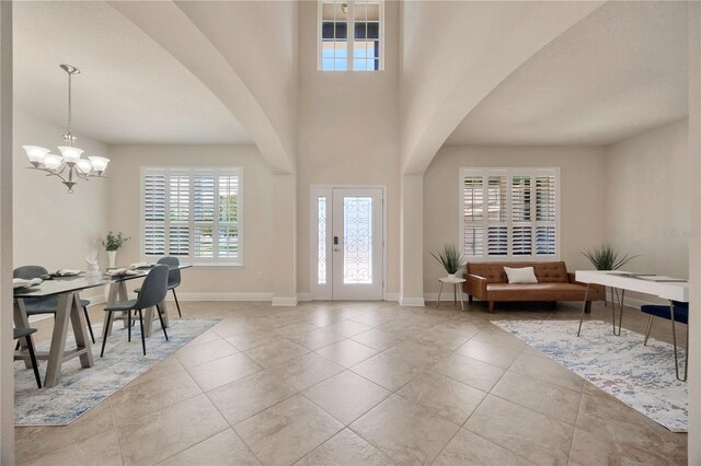 1229 Hillandale Reserve Dr, Tampa, FL 33613 - tiled foyer entrance with a chandelier and arched walkways